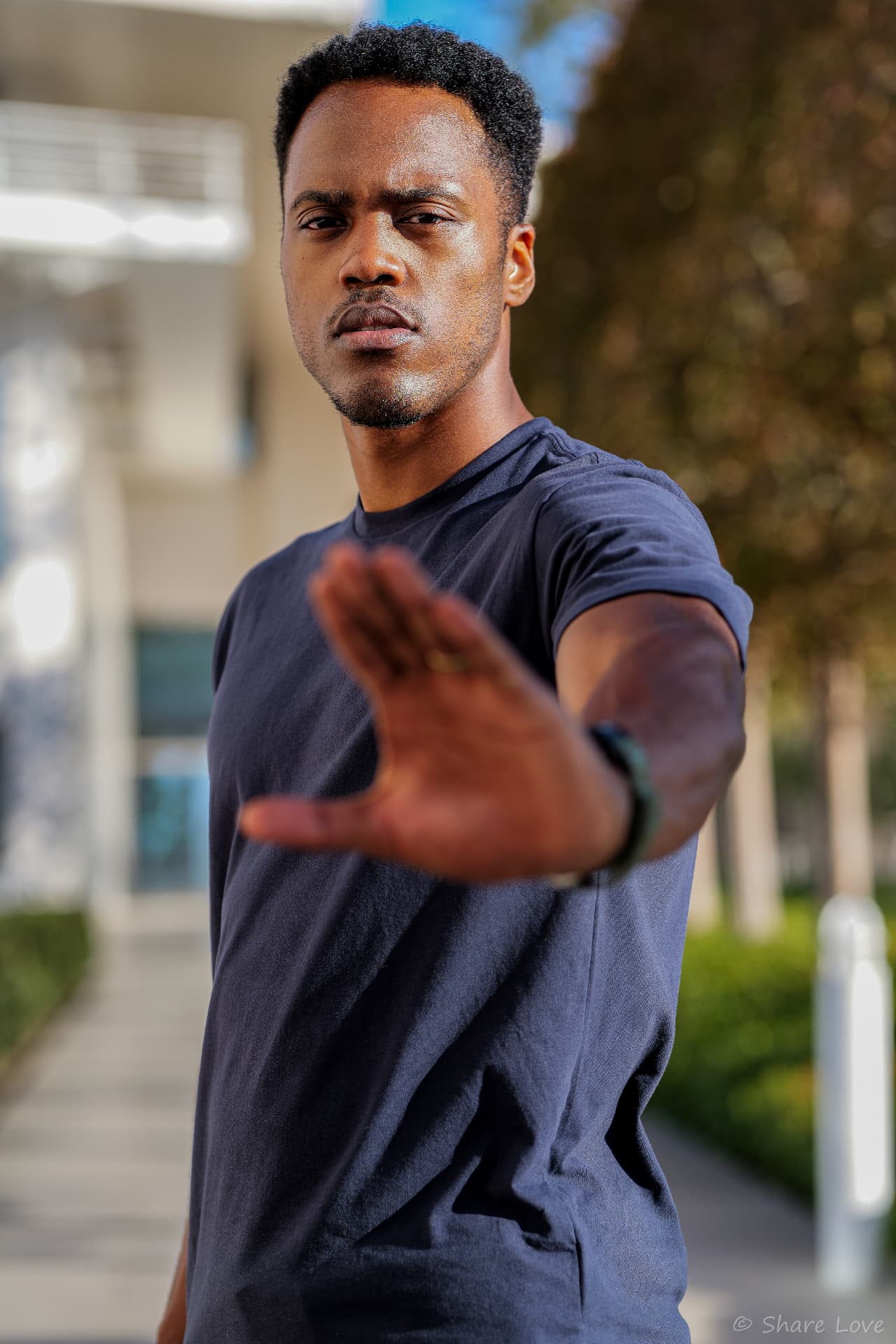 Tash Jordan extending a palm toward the camera in a defensive stance